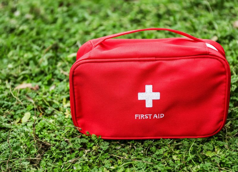First aid kit on green grass outdoors First aid kit on green grass outdoors